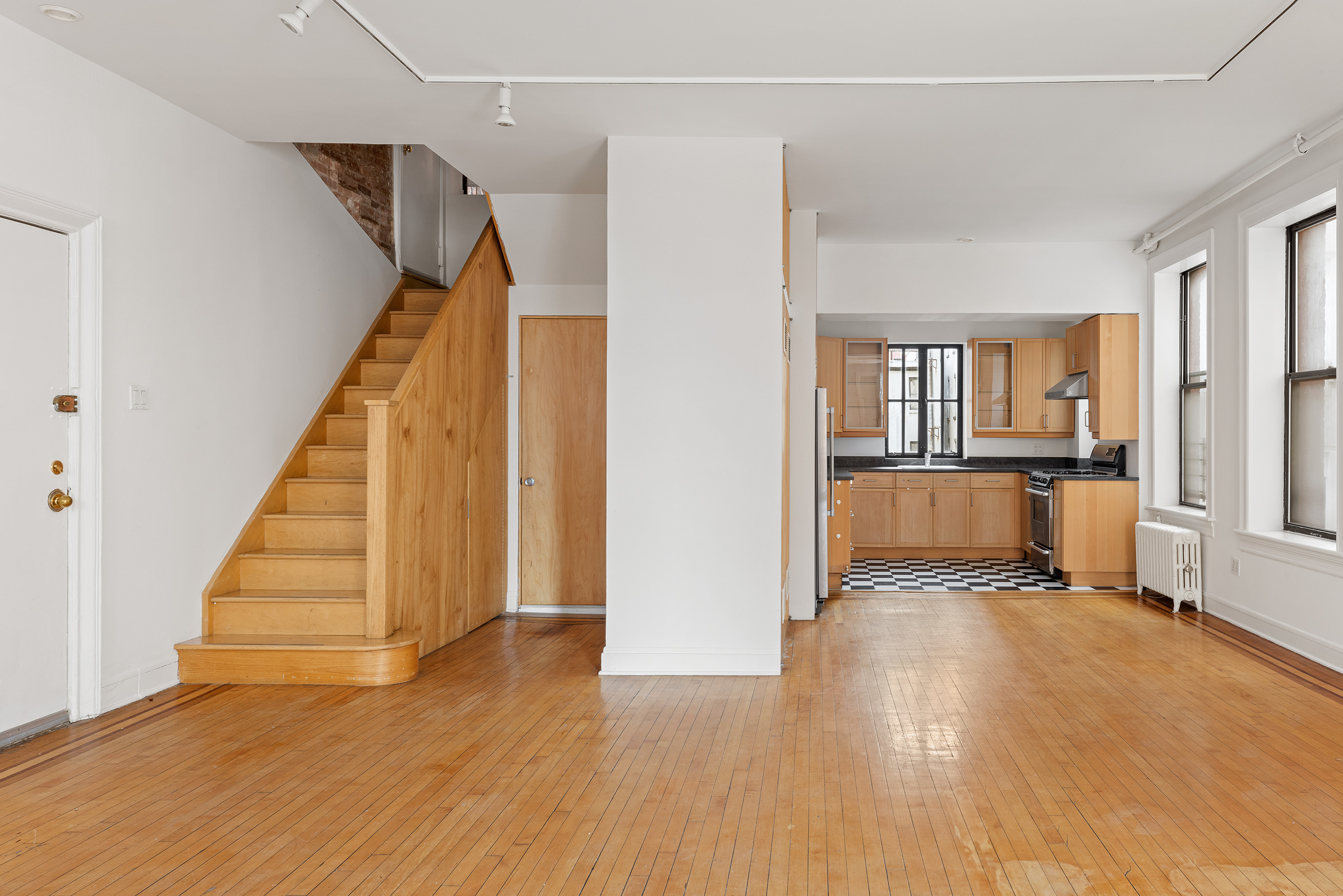 295 East 8th Street, Unit 2/3E Manhattan, NY 10009 - Photo 6 of 23 a view of a room with wooden floor and stairs