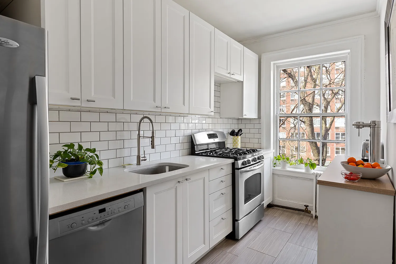 a kitchen with stainless steel appliances granite countertop a sink stove and cabinets