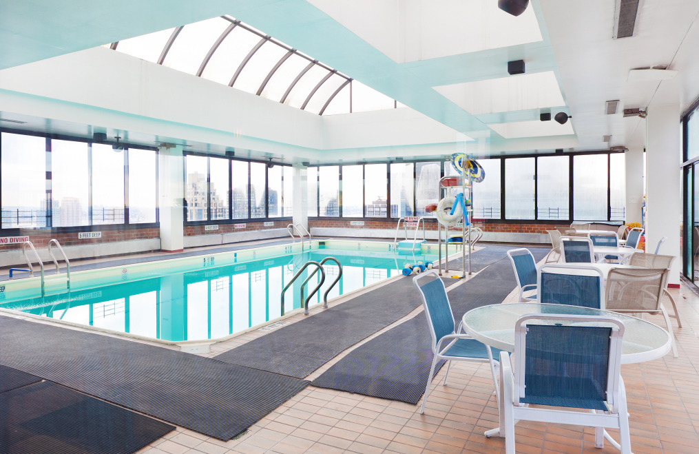 300 East 54th Street, Unit 23J Manhattan, NY 10022 - Photo 11 of 18 a living room with furniture and a large window
