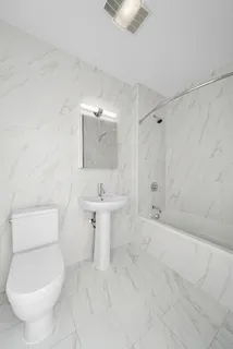 a bathroom with a toilet sink and shower