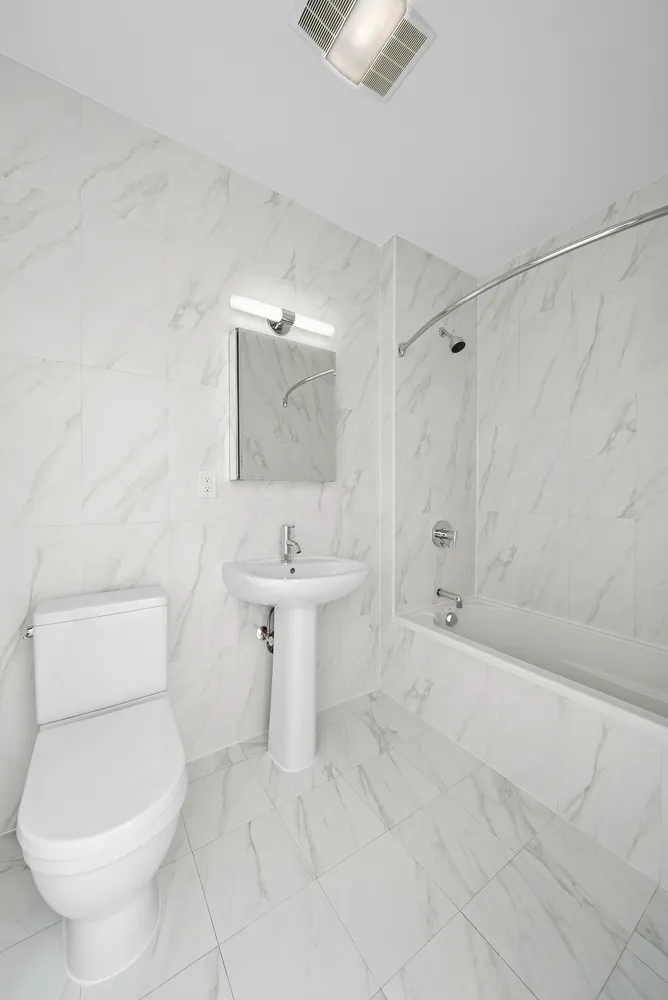 a bathroom with a toilet sink and shower