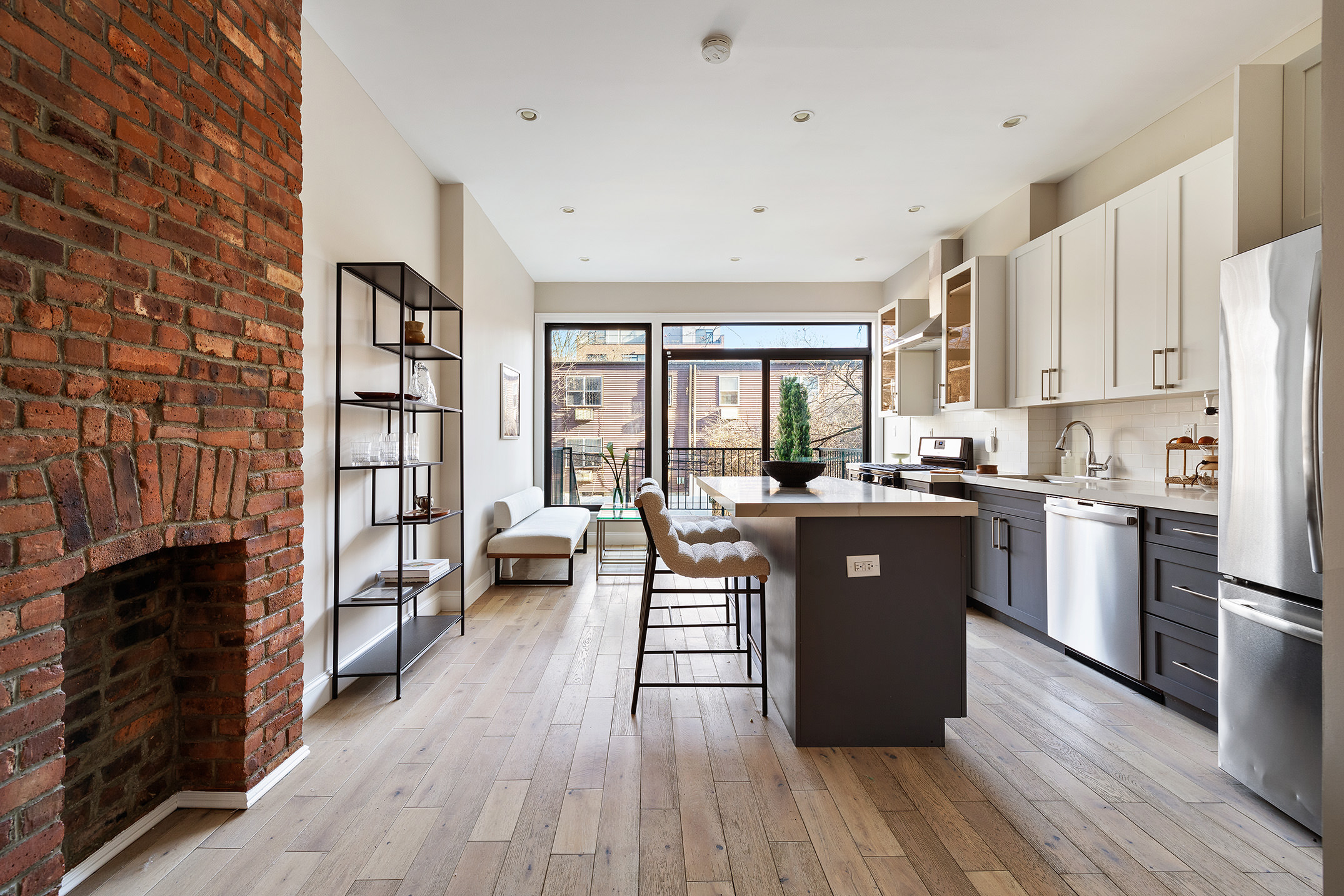 34 Woodbine Street Brooklyn, NY 11221 - Photo 1 of 15 a large kitchen with stainless steel appliances granite countertop a refrigerator a sink dishwasher a stove and a dining table with wooden floor