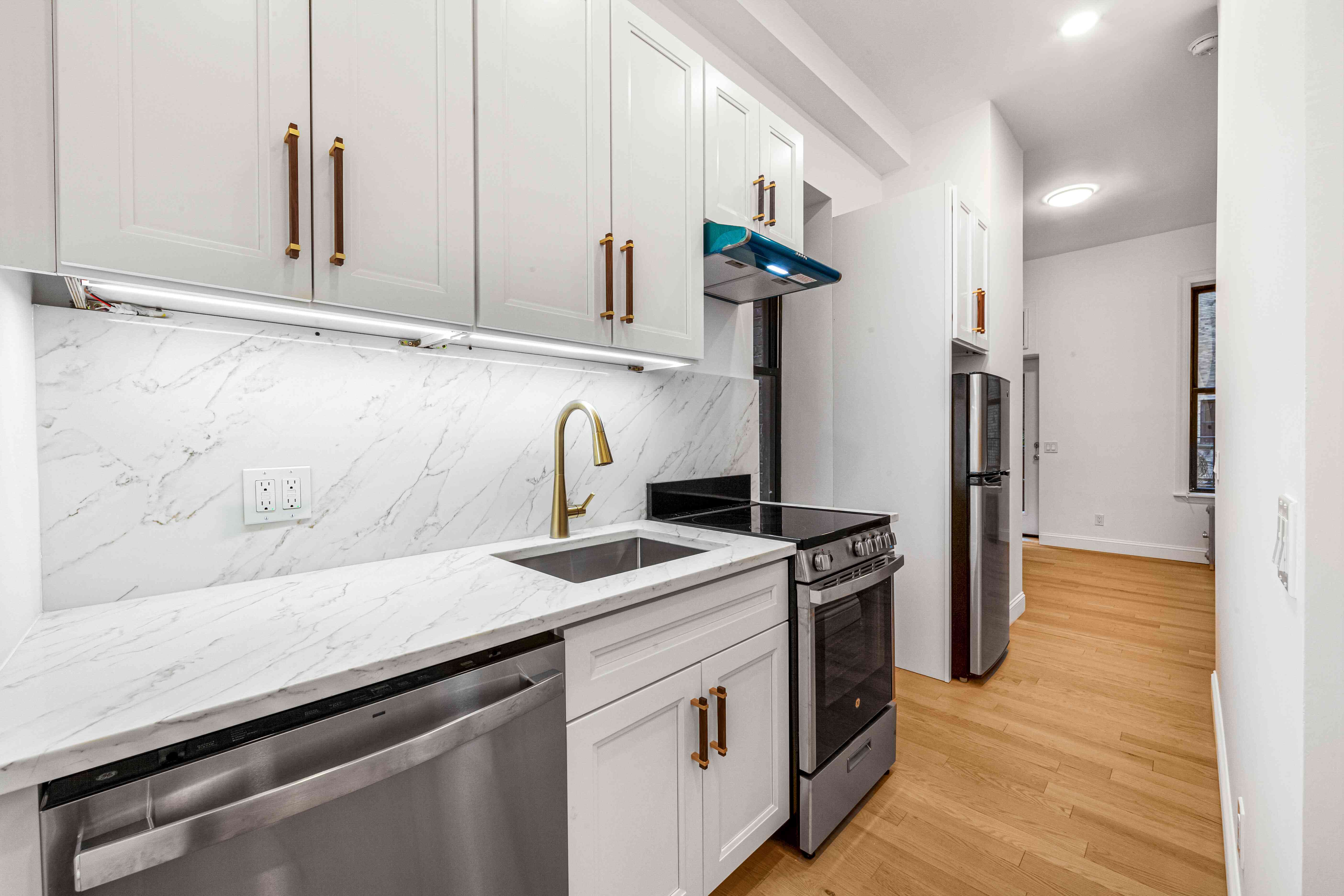 304 East 11th Street, Unit 1C Manhattan, NY 10003 - Photo 10 of 16 a kitchen with stainless steel appliances granite countertop a sink and a stove
