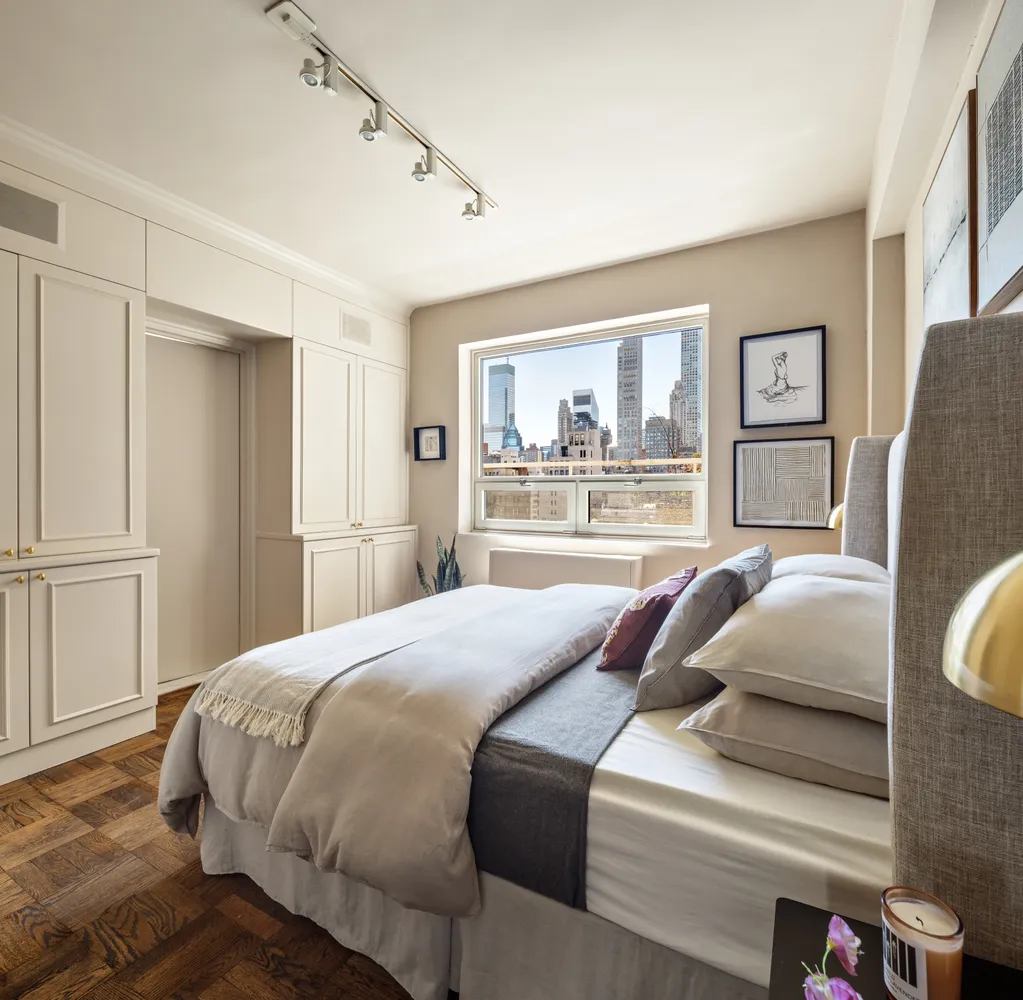 a bedroom with a large bed and a window