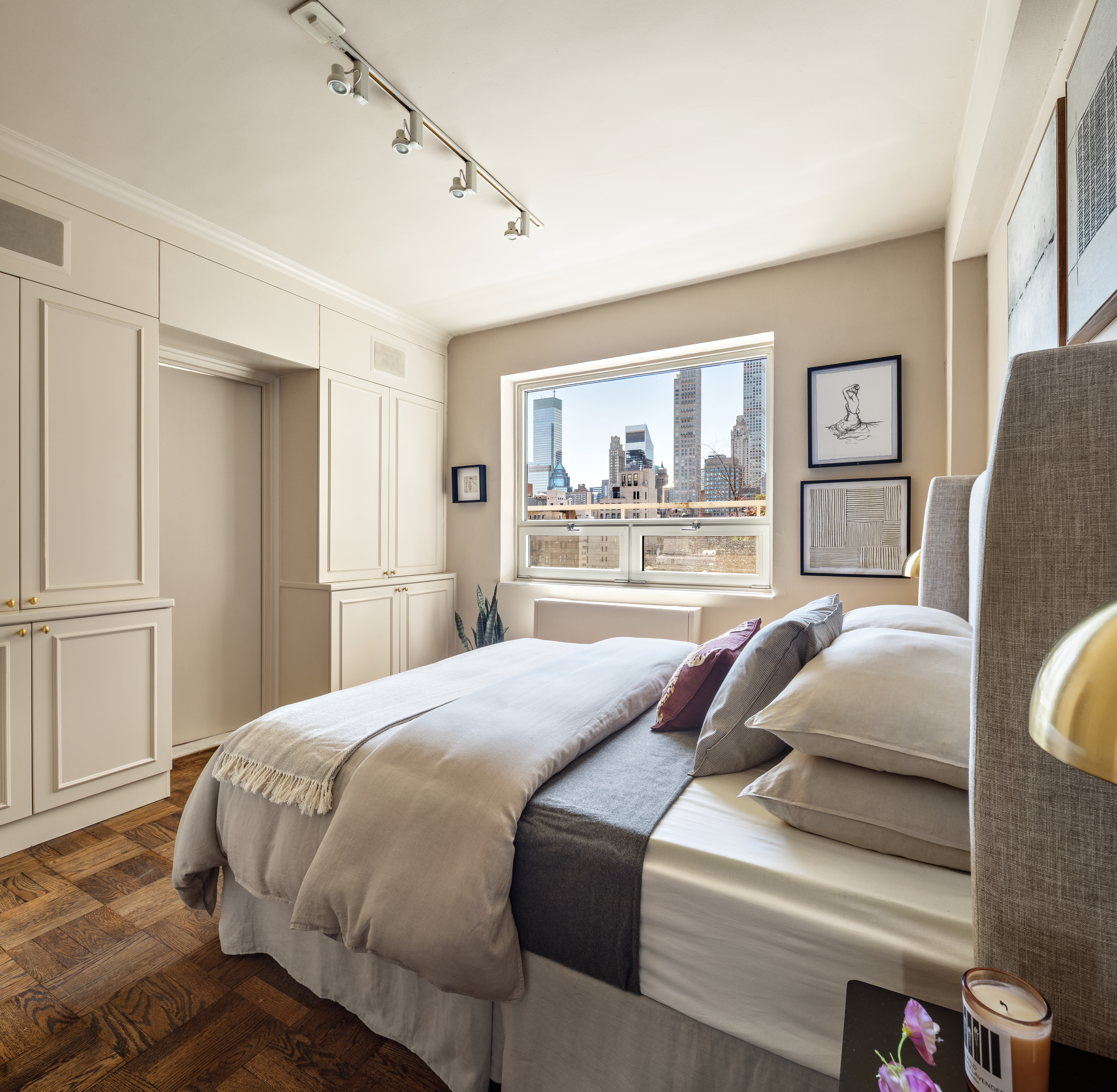860 5th Avenue, Unit 12E Manhattan, NY 10065 - Photo 12 of 16 a bedroom with a large bed and a window