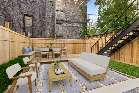 a view of a patio with couches table and chairs and potted plants