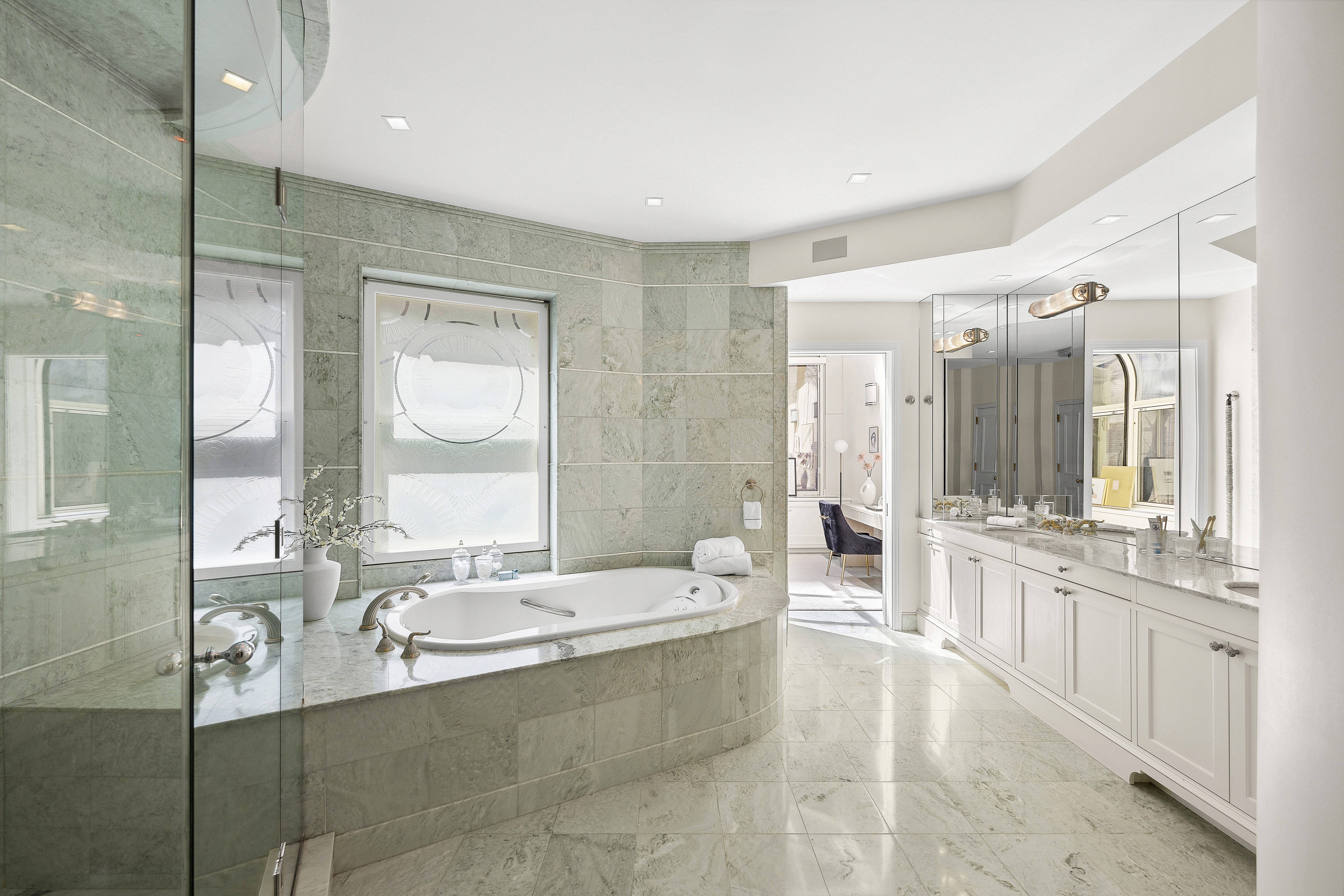 50 East 73rd Street Manhattan, NY 10021 - Photo 8 of 32 a bathroom with a granite countertop tub sink shower and mirror