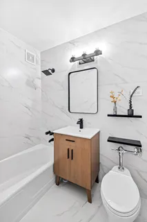 a bathroom with a toilet a sink and bathtub