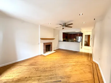 a view of an empty room with a fireplace