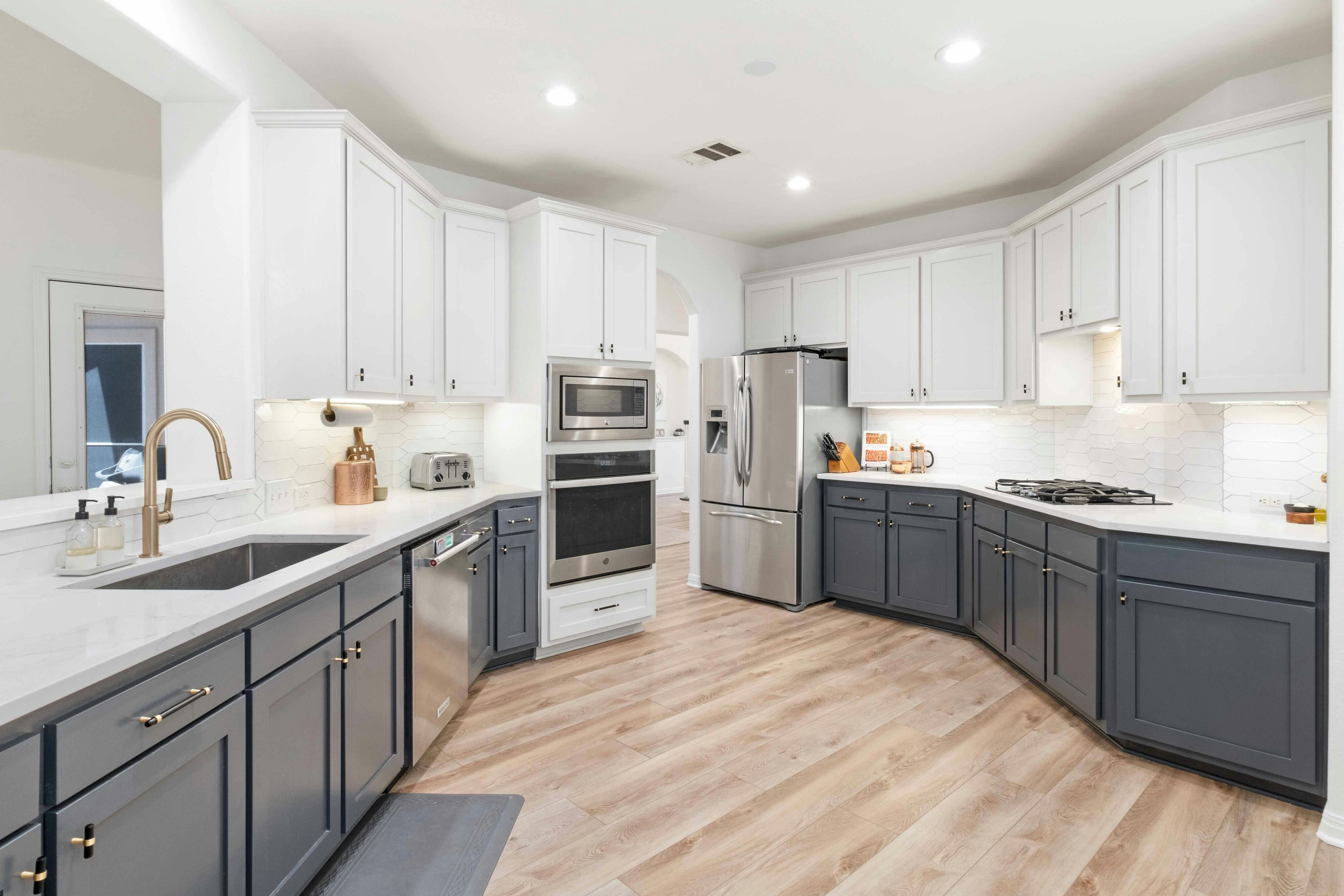 10608 Pointe View Drive Austin, TX 78738 - Photo 13 of 46 a kitchen with kitchen island sink refrigerator and cabinets