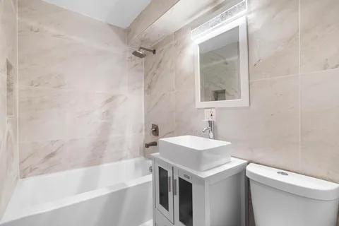 a bathroom with a sink a toilet and a bathtub