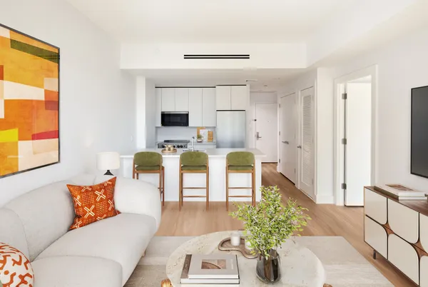 a living room with furniture a flat screen tv and a table