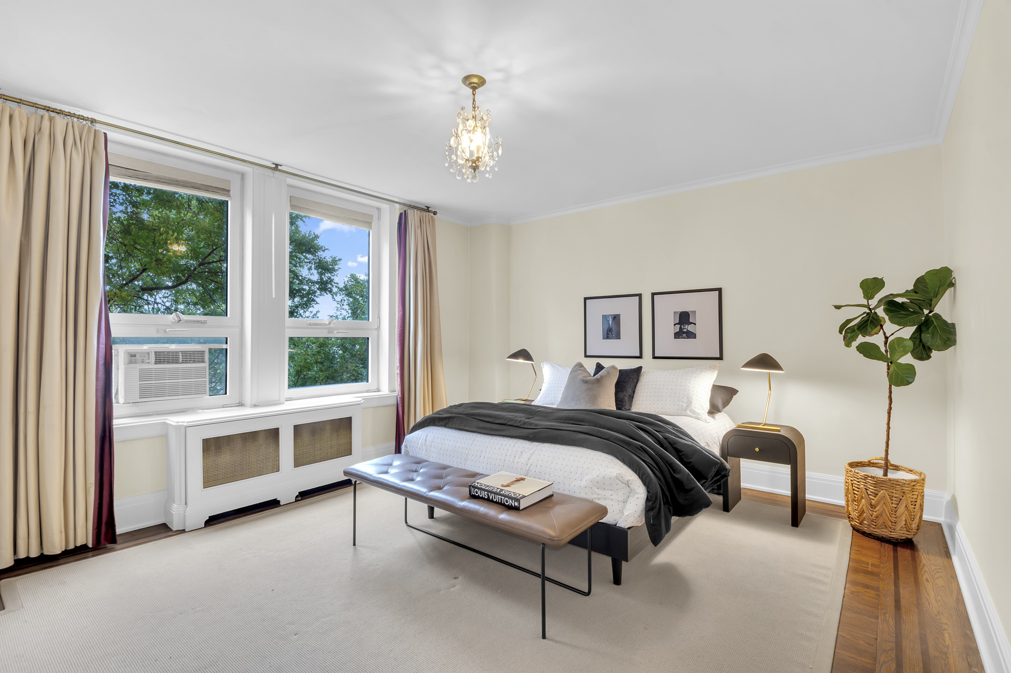 7 Gracie Square, Unit 5A Manhattan, NY 10128 - Photo 8 of 26 a bed room with a bed and a chandelier