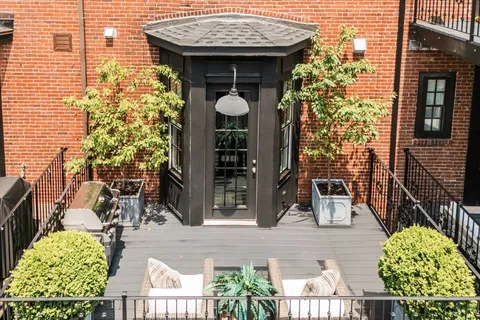 a spacious bedroom with a bed and a flat screen tv