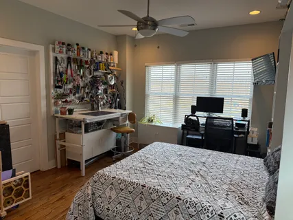 a bedroom with a bed and a television