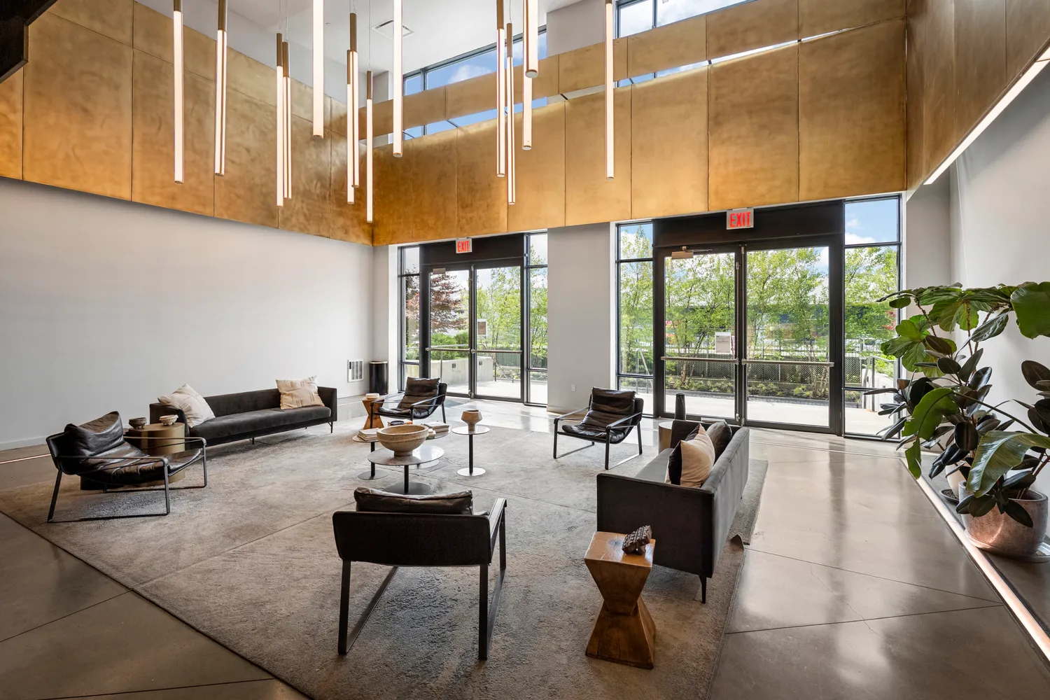 a living room with furniture and floor to ceiling windows