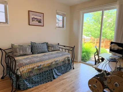 a bedroom with a bed and a wooden floor