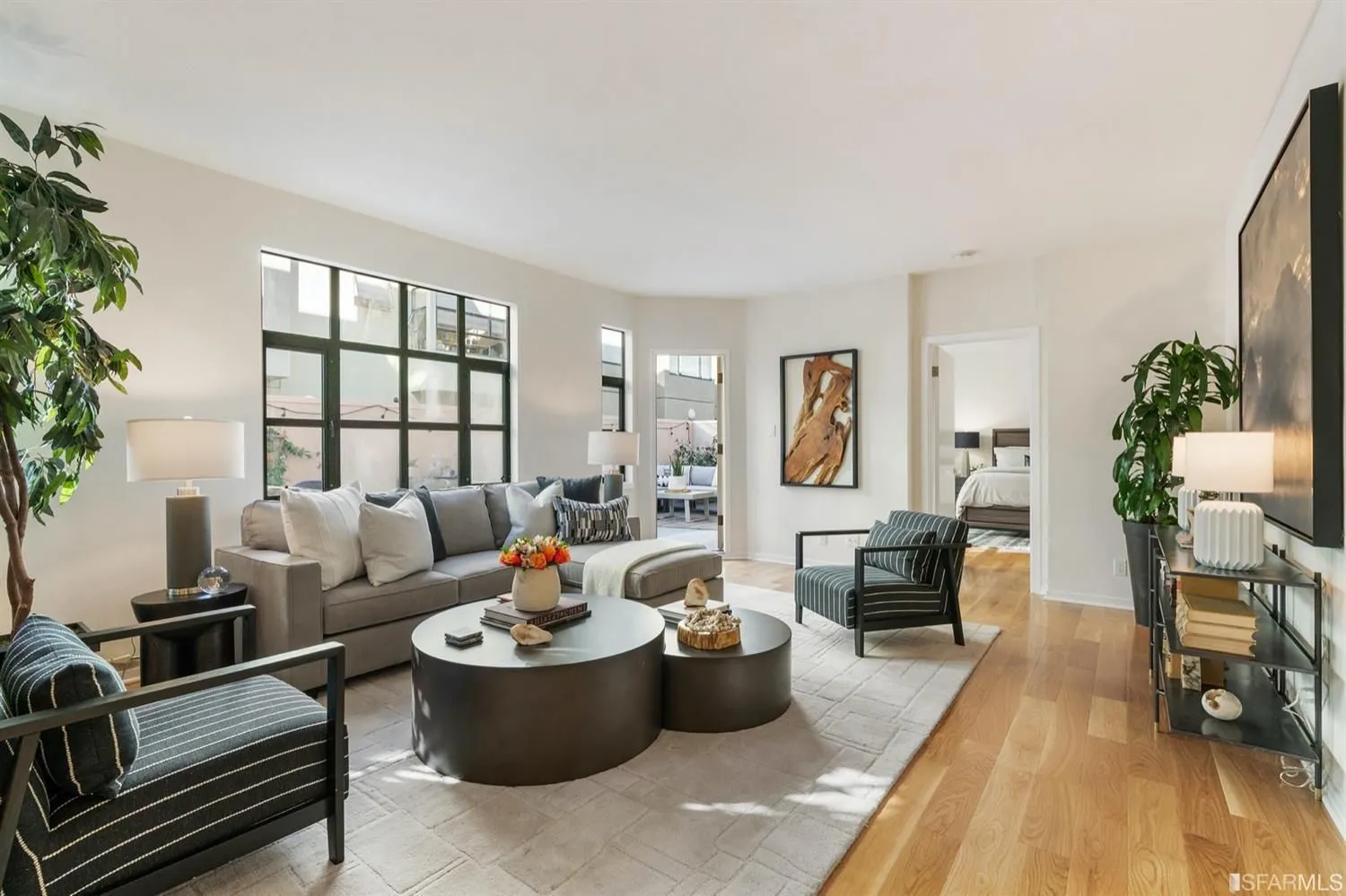 a living room with furniture and a wooden floor