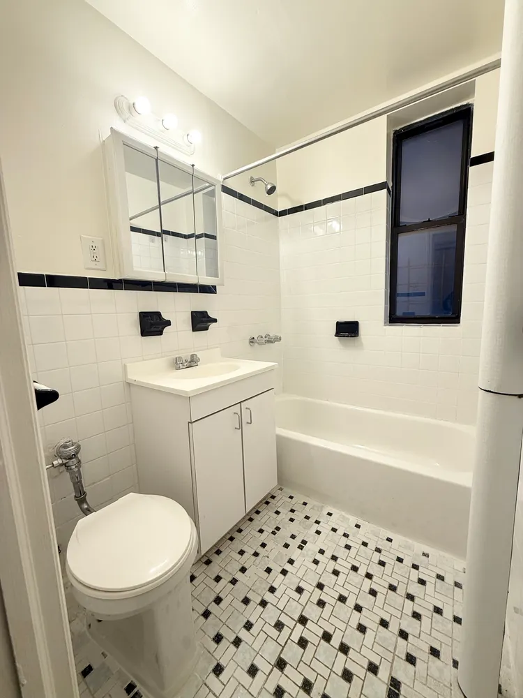 a kitchen with stainless steel appliances granite countertop a refrigerator a sink and white cabinets