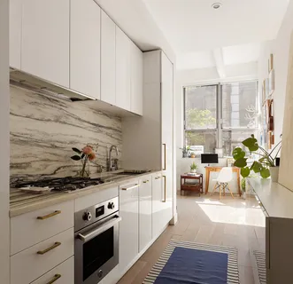 a kitchen with a stove cabinets and wooden floor