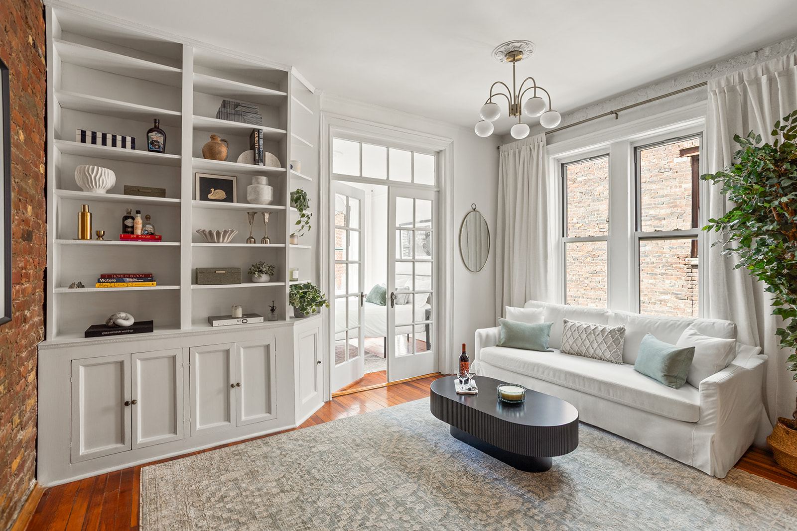 a living room with furniture and a chandelier