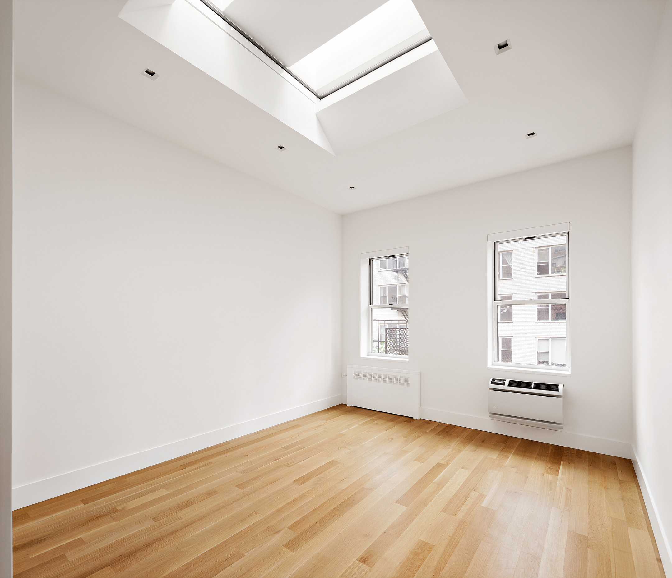 435 East 85th Street, Unit 4P Manhattan, NY 10028 - Photo 2 of 9 a view of empty room with wooden floor and fan