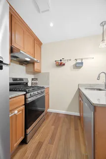 a kitchen with granite countertop a sink and a stove top oven