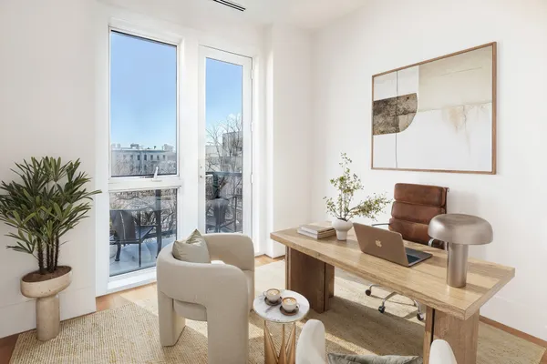 a living room with furniture and potted plant