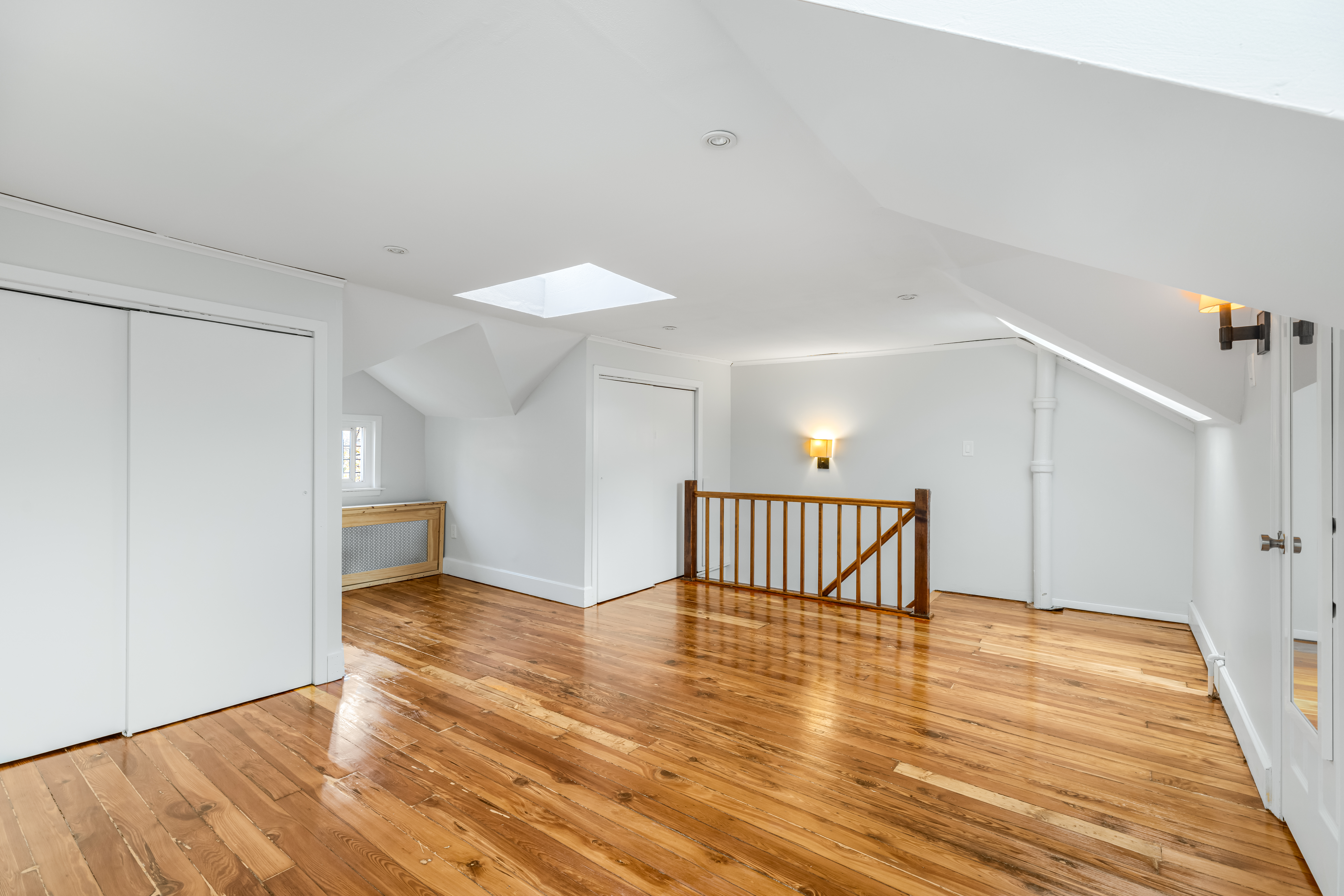 180 East 5th Street, Unit 2 Brooklyn, NY 11218 - Photo 11 of 14 a view of a room with wooden floor and white walls