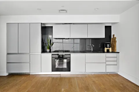 a kitchen with stainless steel appliances a stove refrigerator sink and cabinets