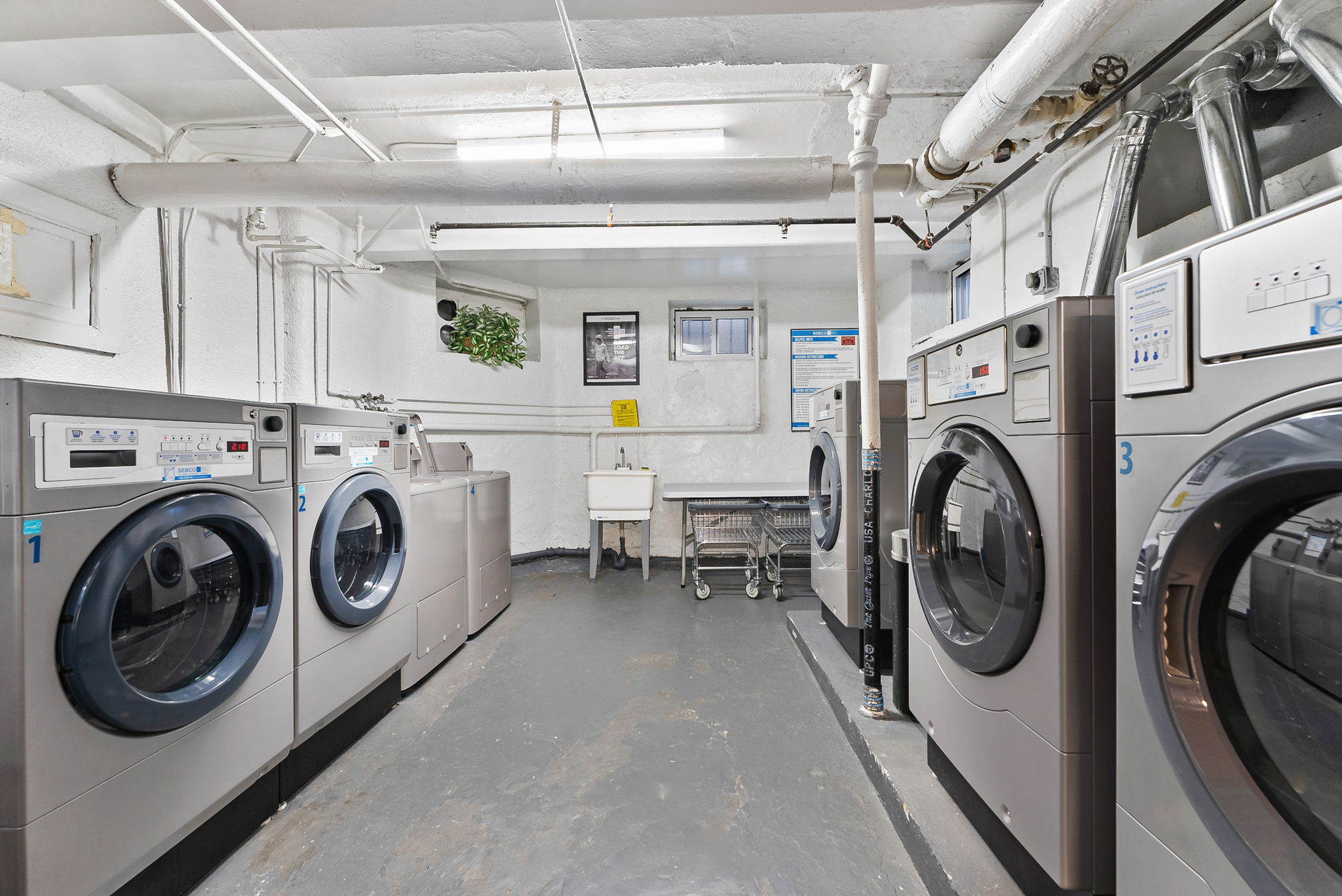 9615 Shore Road, Unit 4B Brooklyn, NY 11209 - Photo 11 of 13 a utility room with dryer washer and a view of living room