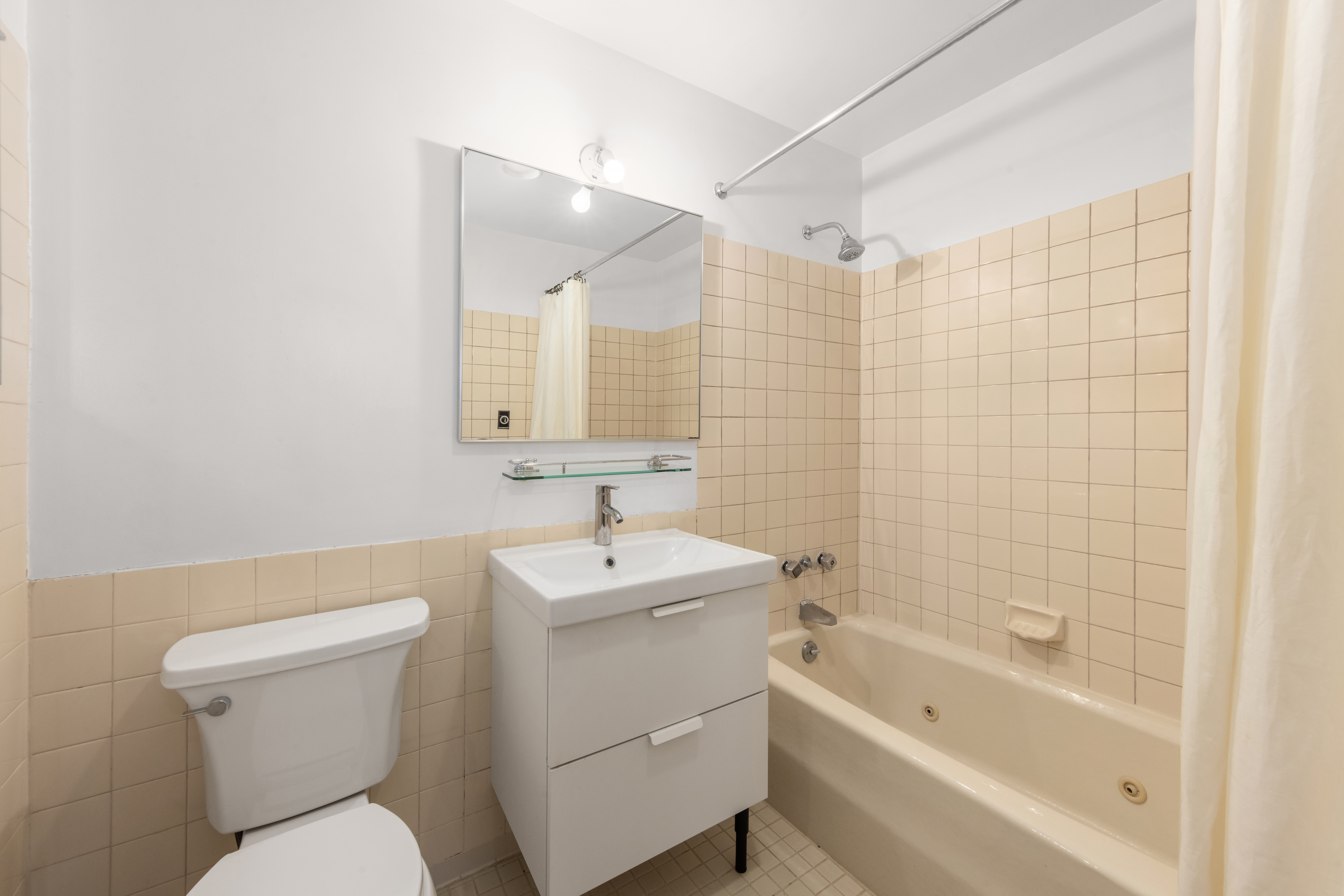 65 Leonard Street, Unit 4 Manhattan, NY 10013 - Photo 8 of 10 a bathroom with a sink toilet and shower