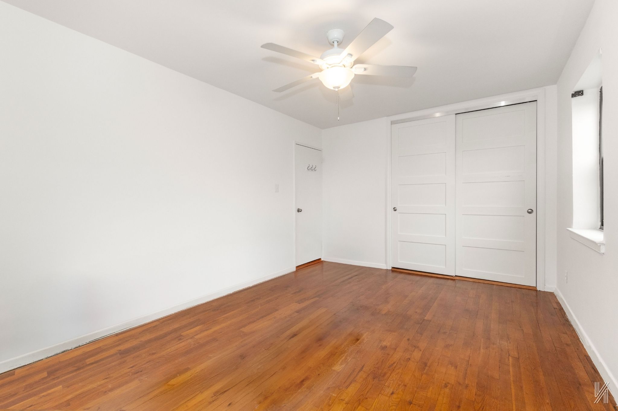 34-10 94th Street, Unit 6G Queens, NY 11372 - Photo 10 of 19 a view of empty room with wooden floor