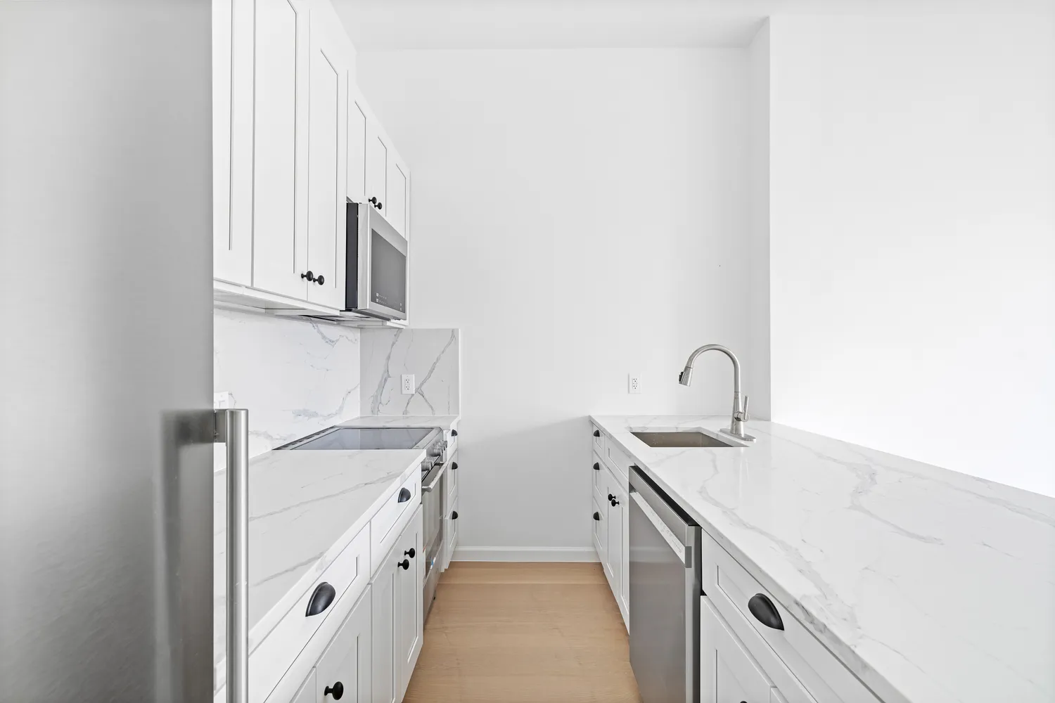 a kitchen with white cabinets and a sink