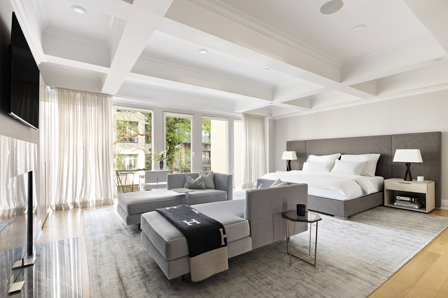 554 East 82nd Street, Unit 1/2 Manhattan, NY 10028 - Photo 4 of 13 a living room with furniture and a flat screen tv