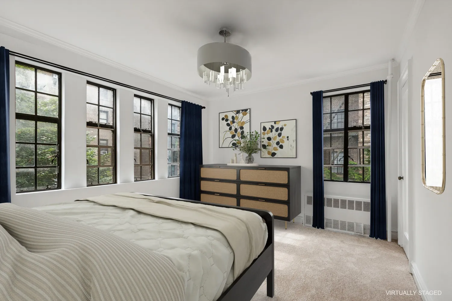 a bedroom with a large bed and a chandelier