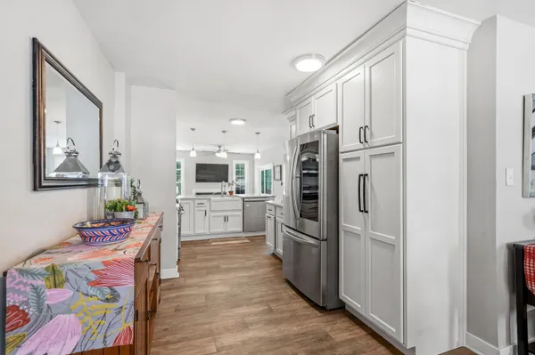 a kitchen with stainless steel appliances a refrigerator and a stove top oven