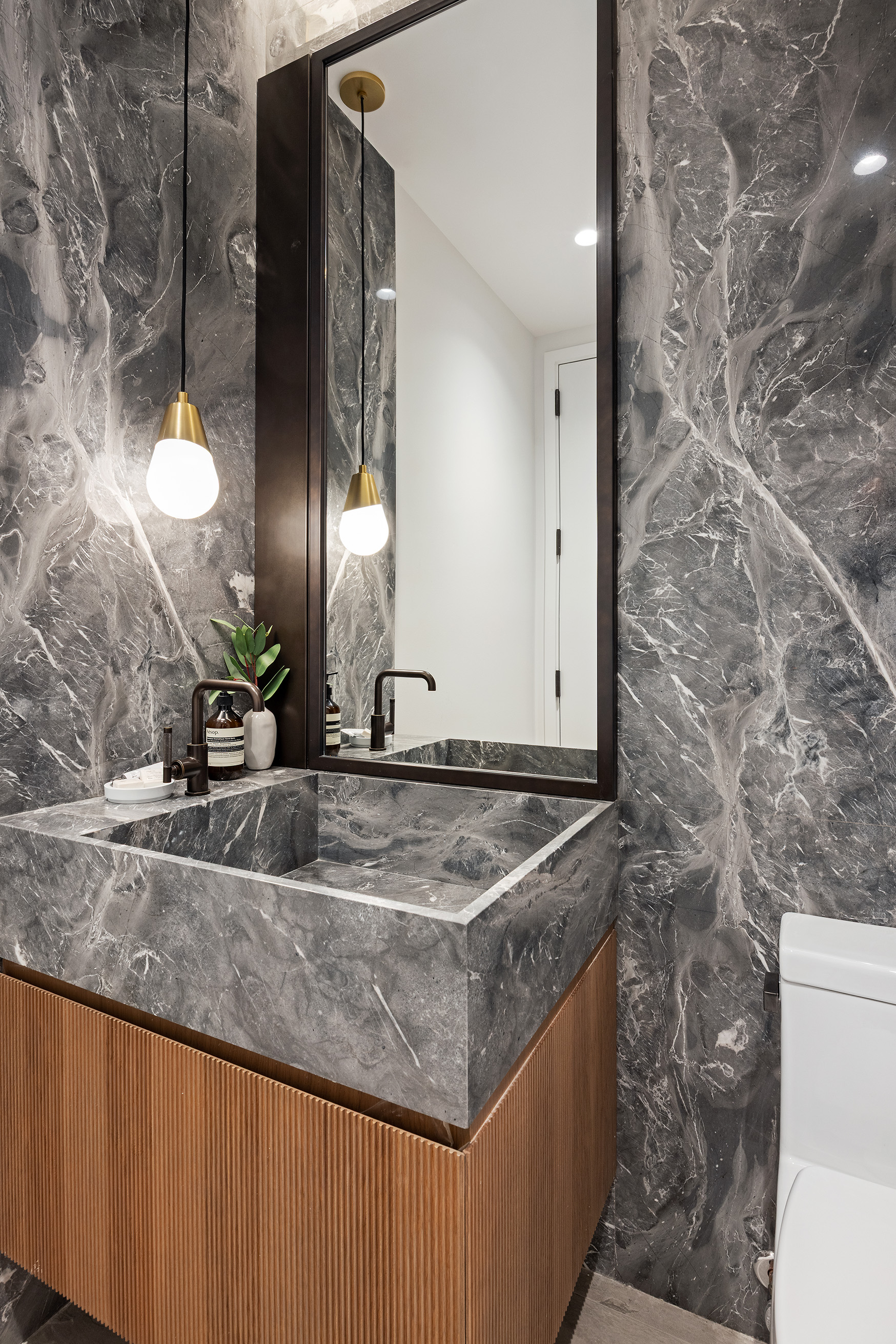 62 Reade Street, Unit 4 Manhattan, NY 10007 - Photo 18 of 20 a bathroom with a granite countertop sink and a mirror