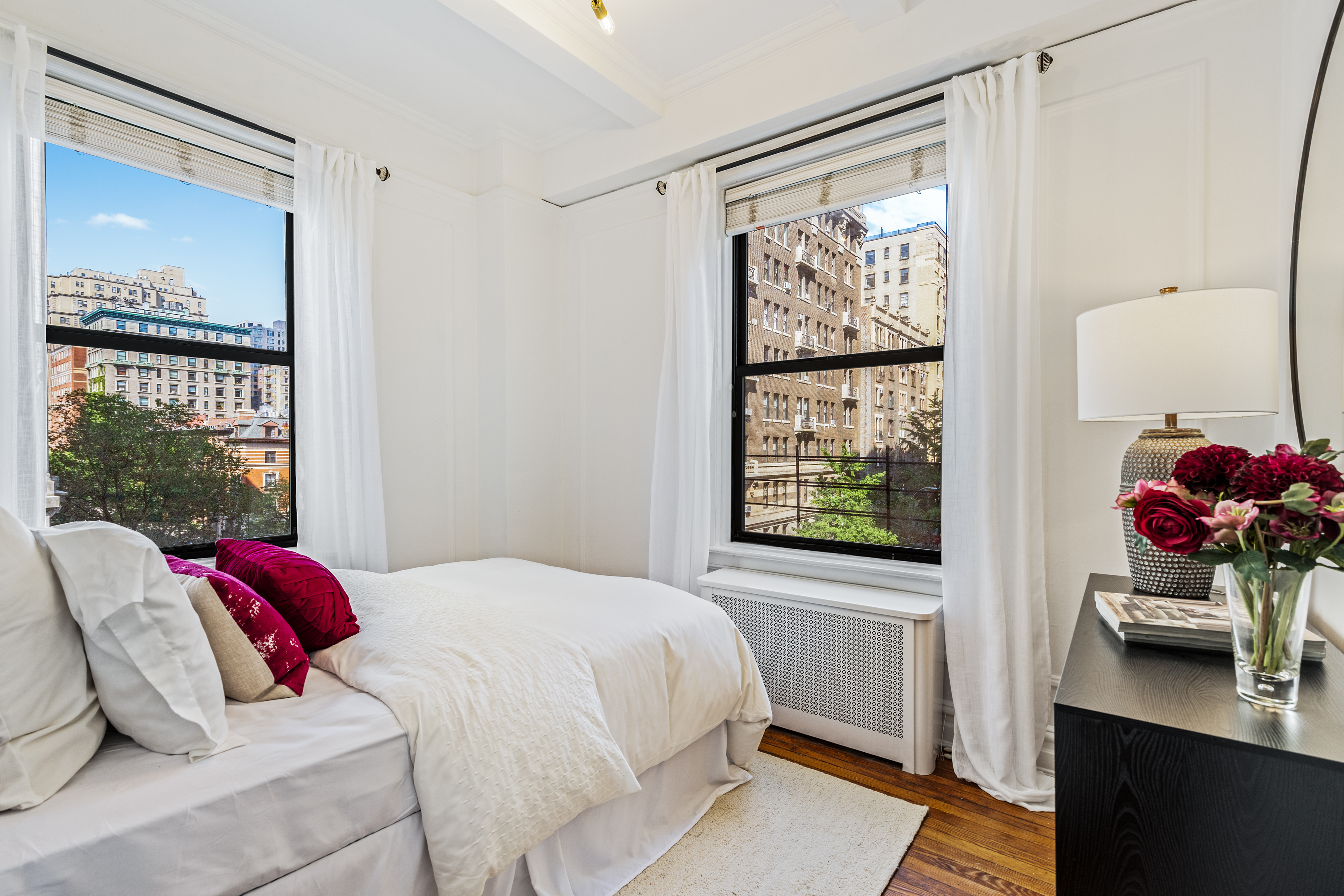 599 West End Avenue, Unit 5A Manhattan, NY 10024 - Photo 7 of 11 a bedroom with a bed and glass window