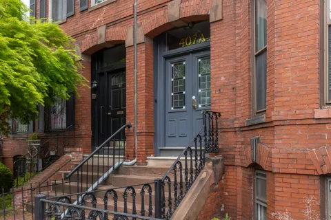 a view of a brick house with many windows