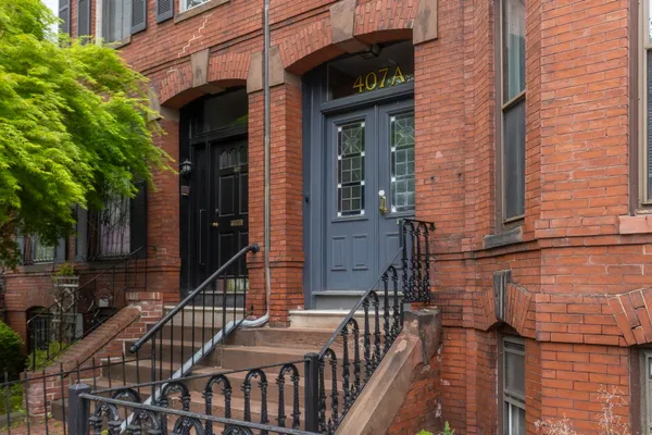 a view of a brick house with many windows