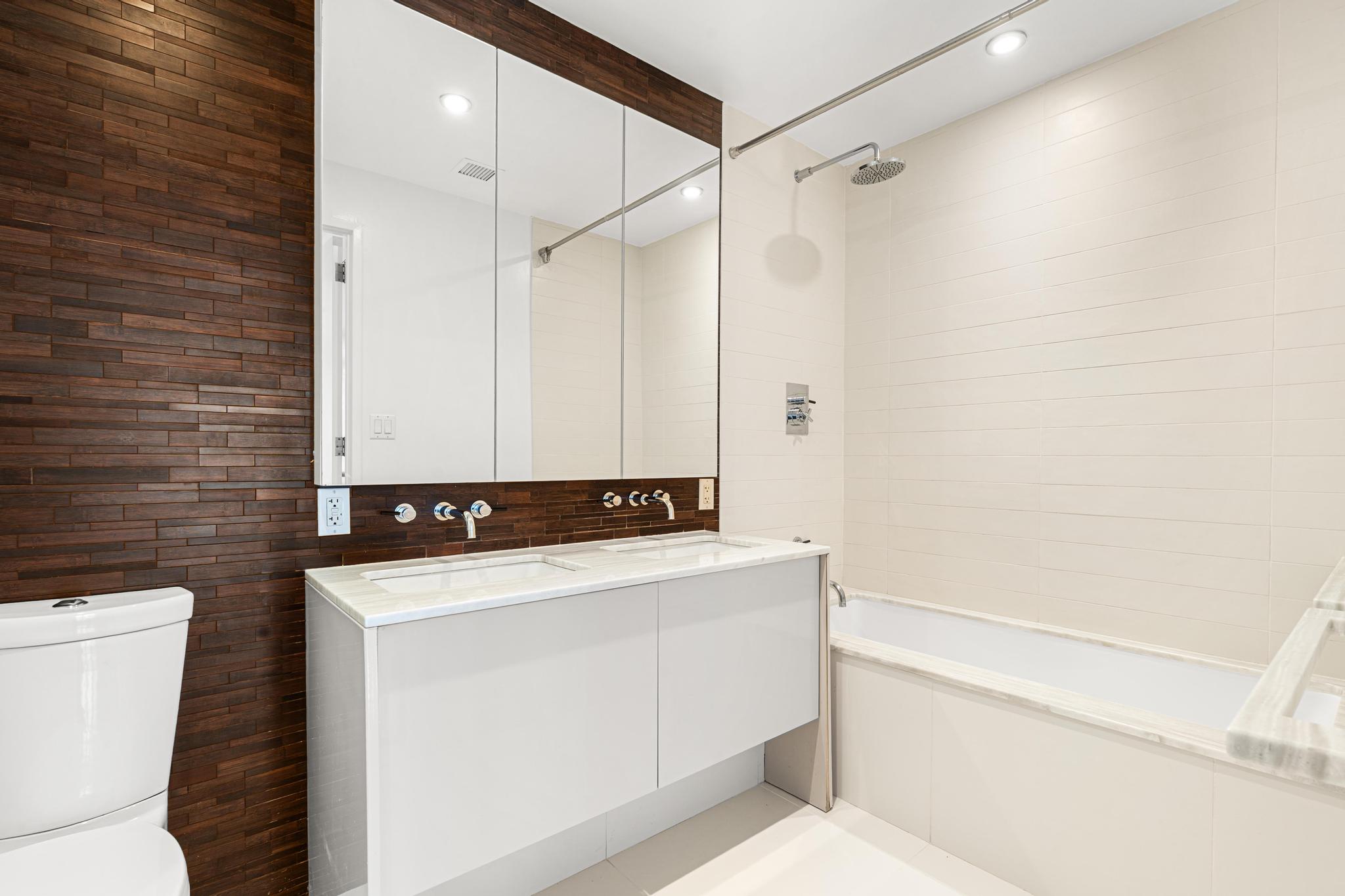 2 Northside Piers, Unit 5U Brooklyn, NY 11249 - Photo 10 of 12 a bathroom with a sink a toilet and a shower