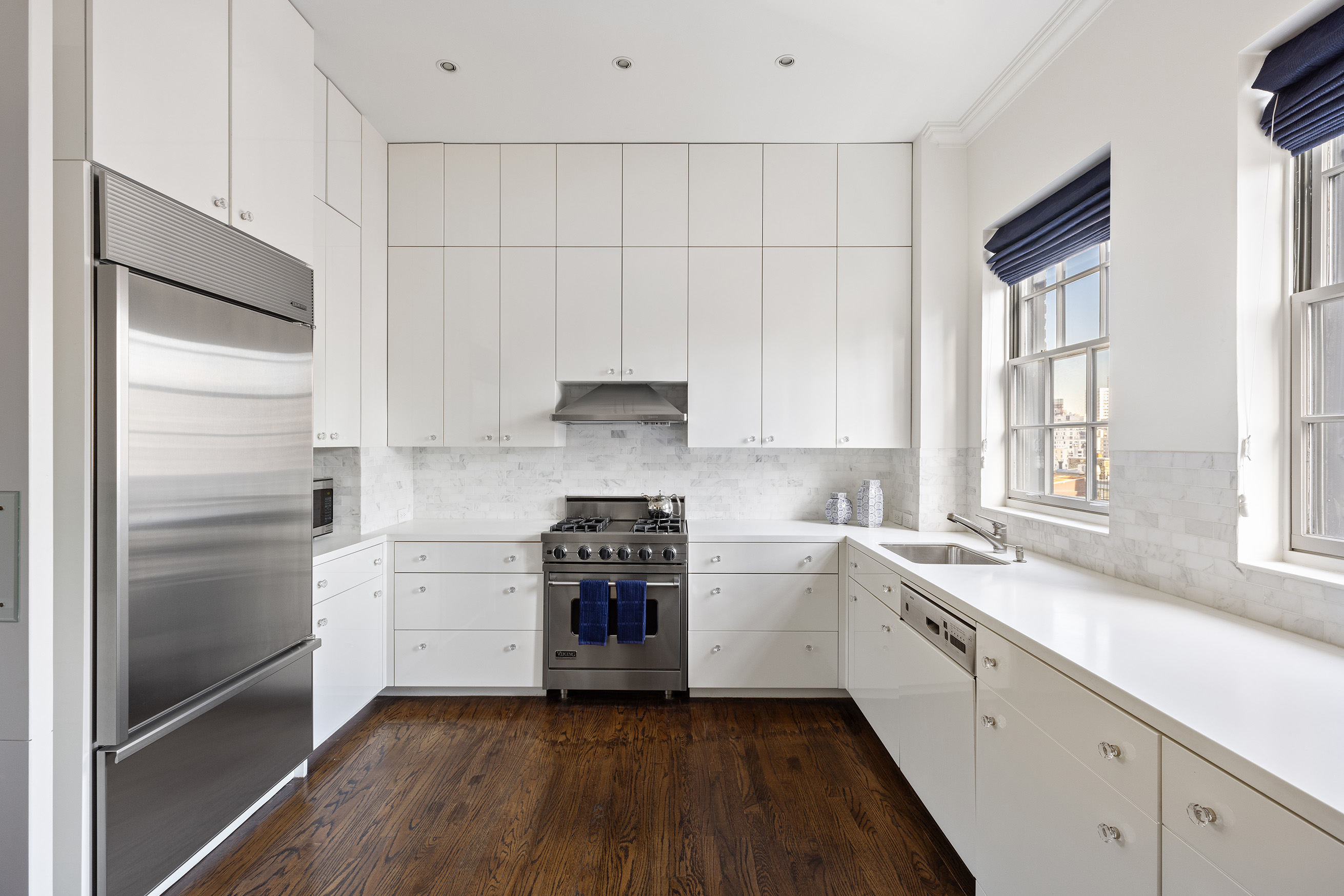 535 Park Avenue, Unit 14C Manhattan, NY 10065 - Photo 14 of 18 a kitchen with stainless steel appliances white cabinets and a sink