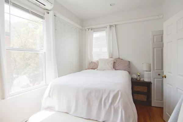 a bedroom with a bed and a window