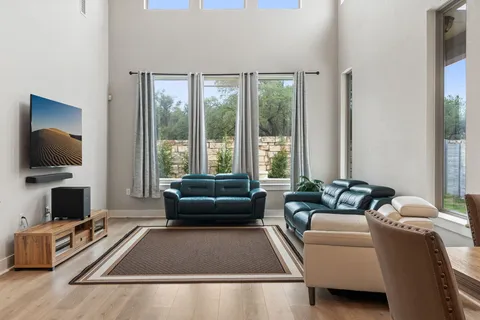 a living room with furniture rug and flat screen tv
