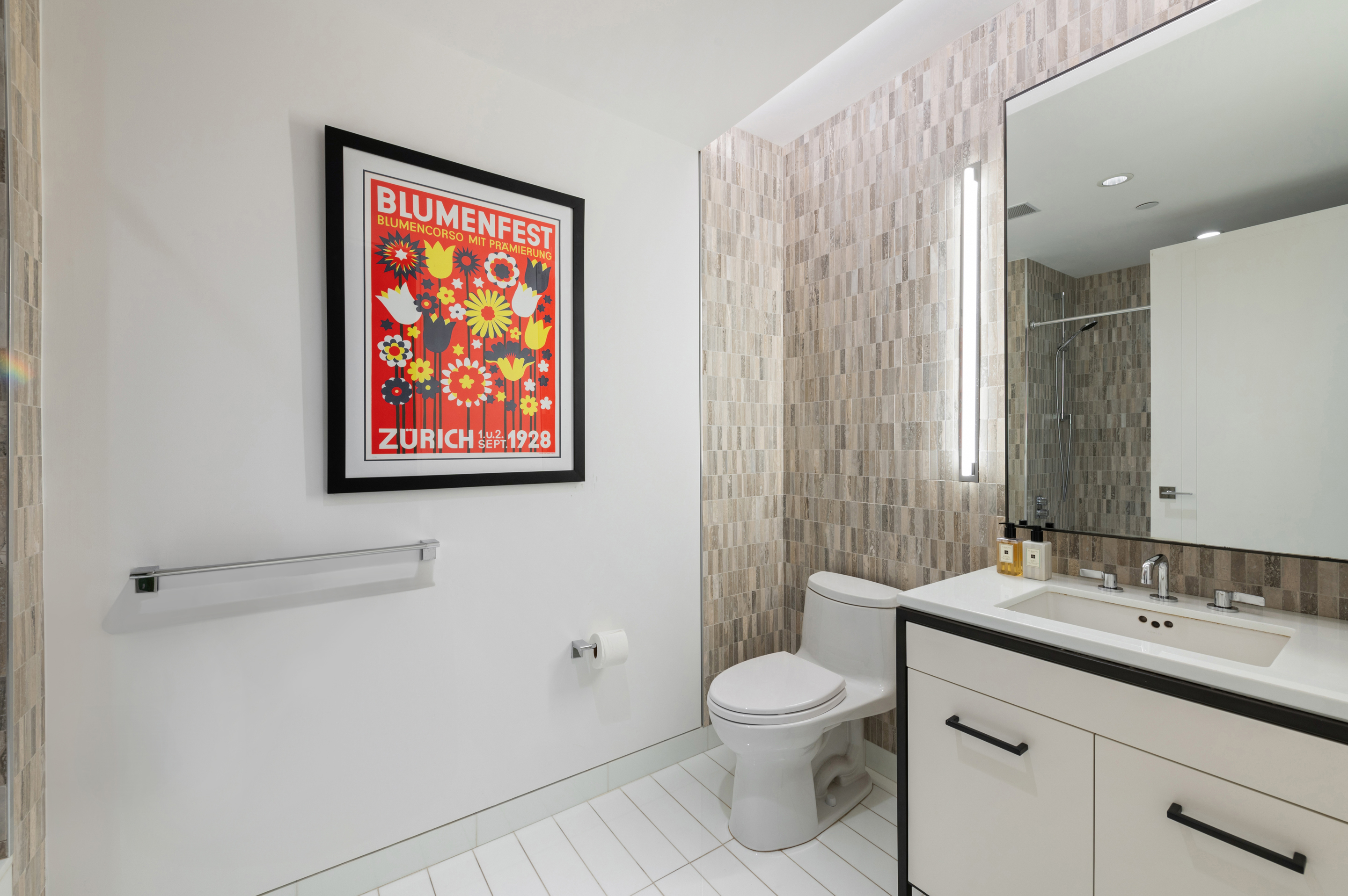 70 Charlton Street, Unit 16C Manhattan, NY 10014 - Photo 20 of 31 a bathroom with a toilet sink and mirror