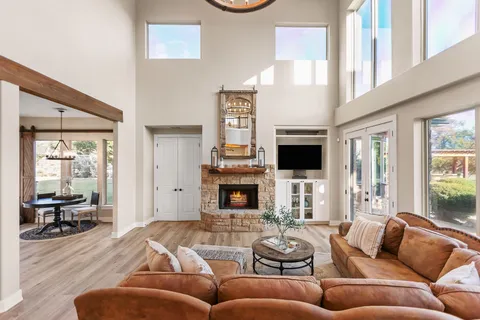 a living room with furniture a fireplace and a flat screen tv