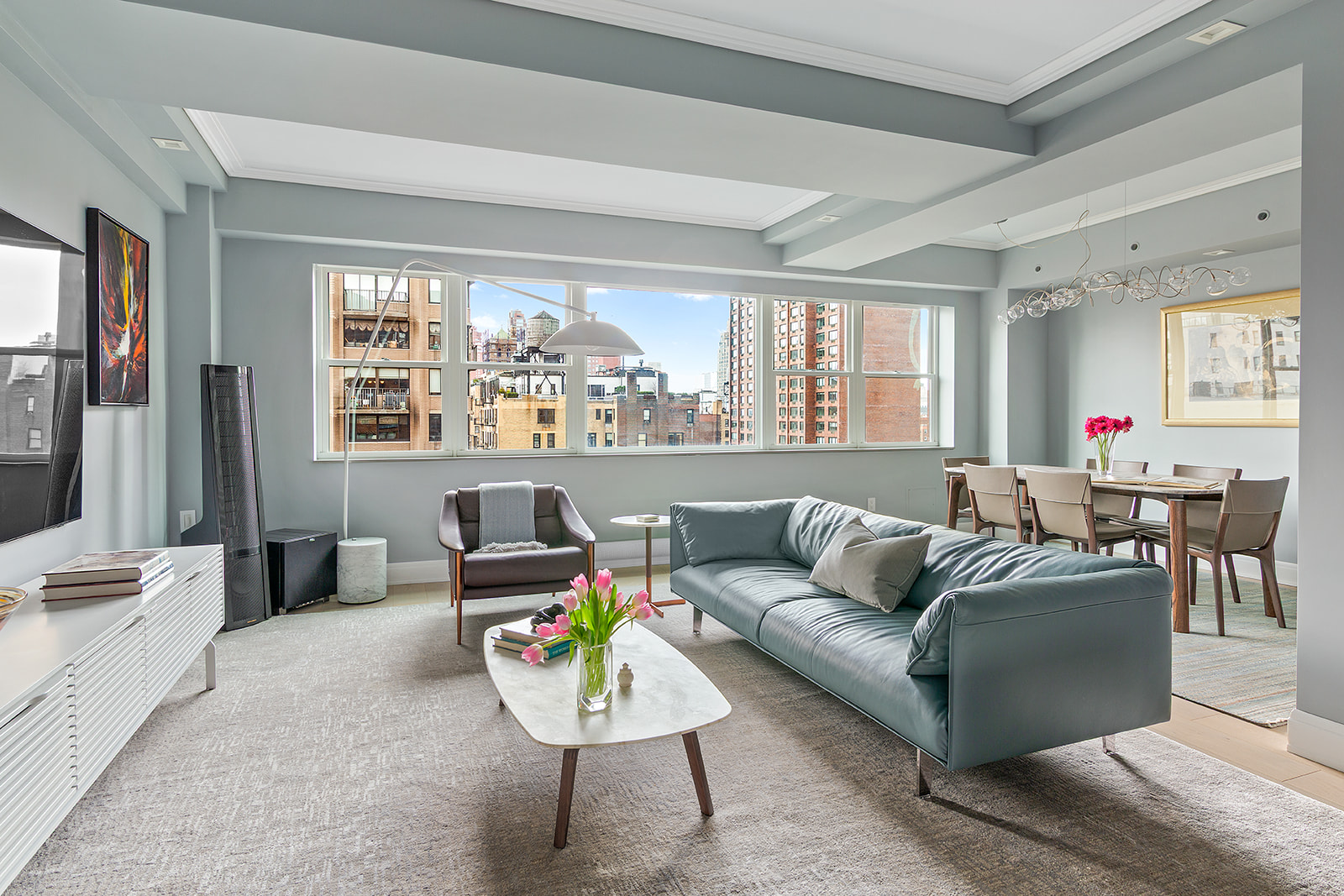 165 East 72nd Street, Unit 17L Manhattan, NY 10021 - Photo 1 of 12 a living room with furniture and a large window