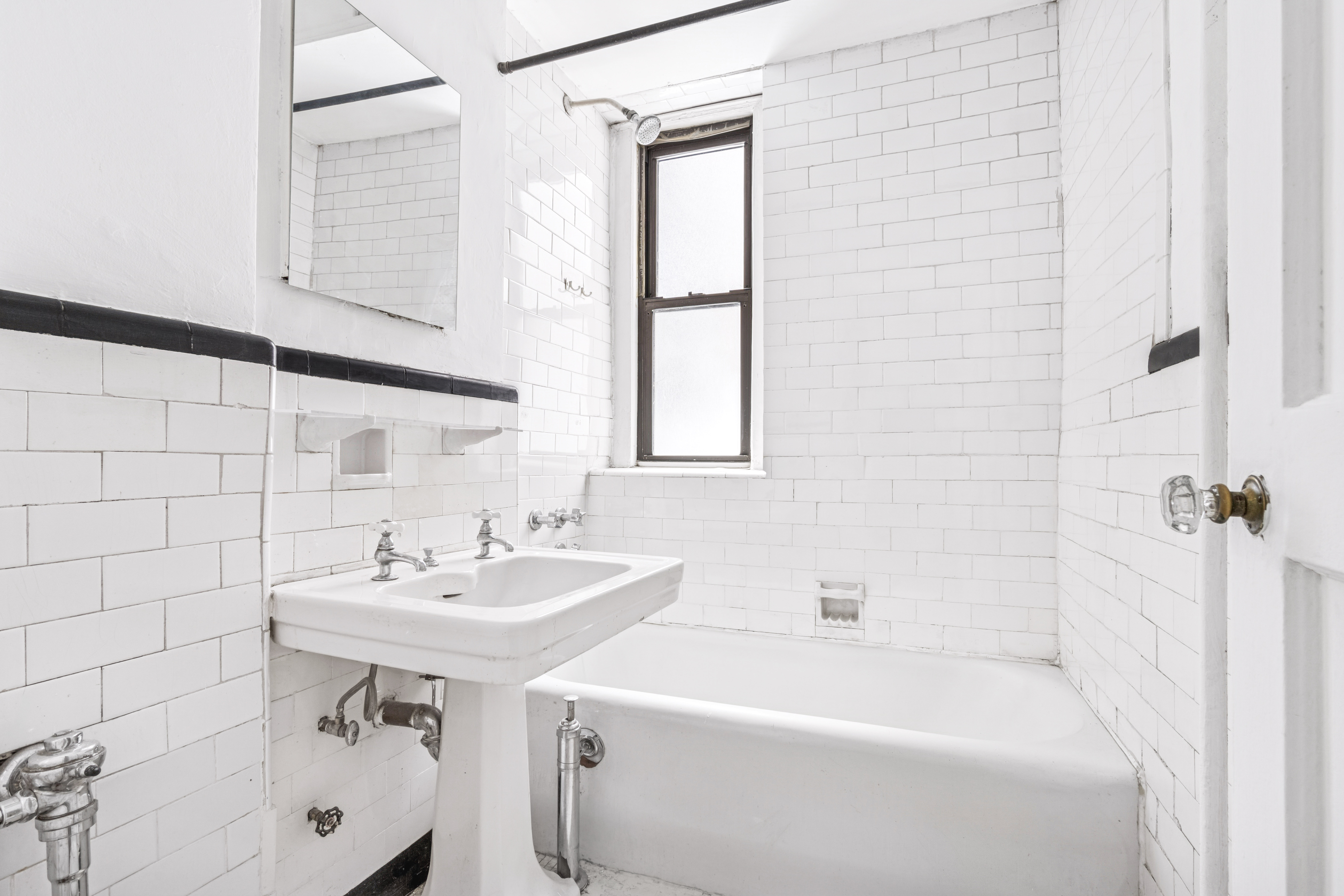 130 West 16th Street, Unit 3 Manhattan, NY 10011 - Photo 5 of 8 a bathroom with a sink a mirror and a bathtub