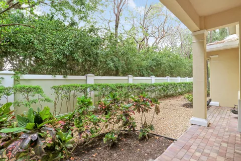 a front view of a house with a yard and potted plants
